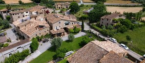 A residential area with stone buildings, paved streets, and green spaces. - Two 18th-century country houses 'Can Gat Vell' with private pool, Wi-Fi, AC, fans (LLAMPAIES)