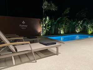 A nighttime poolside area with lounge chairs and a sign reading 'Ramay Villa.' - Villa Ramay - Boutique Pool Villa - 5 Minutes to Fisherman's Village (Amphoe Ko Samui)
