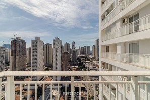 A high-rise building with multiple balconies and a cityscape in the background. - Studio With Balcony in Condo With Pool - Wbu2615 (Goiânia)