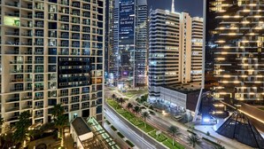 A high-rise building with multiple floors, large windows, and a prominent tower. - Canal View Suite | DAMAC Maison Privé | 4 Guests (Dubai)