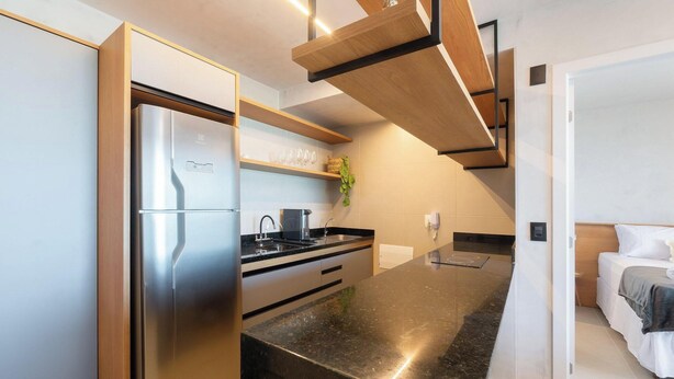 A modern kitchen with a built-in refrigerator, a sink, and a countertop. - Apartment w/ sea View in Building w/ Pool Edf1303 (Salvador)