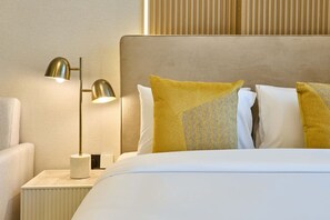 A hotel room with a bed, a nightstand, a lamp, and a wall with vertical blinds. - Modern Studio | Rooftop Infinity Pool | Arjan (Dubai)