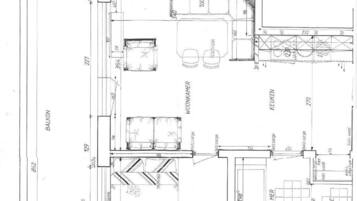 A floor plan with a balcony, kitchen, and living area.