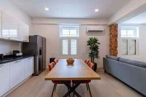A modern kitchen with a dining table, chairs, and a built-in oven. - History Comfort Character in Willemstad (Willemstad)