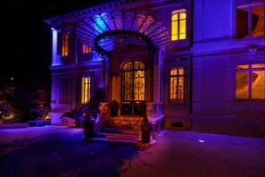 A large, two-story building with a grand entrance featuring a decorative archway and a set of stairs leading up to the door. - Classic South of France elegances set in an oasis in the heart of Cannes (Cannes)
