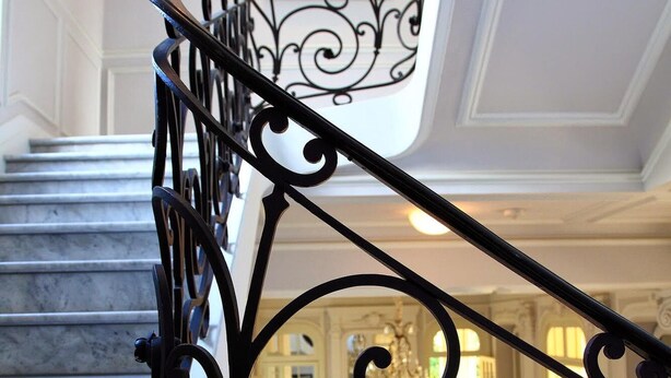 A staircase with ornate black metal railings leading to a landing. - Classic South of France elegances set in an oasis in the heart of Cannes (Cannes)