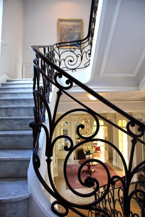 A staircase with ornate black metal railings leading to a landing. - Classic South of France elegances set in an oasis in the heart of Cannes (Cannes)