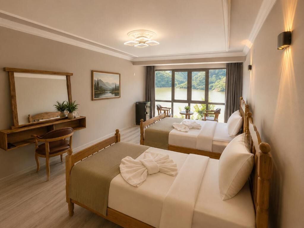 A hotel room with two beds, a desk, a chair, a mirror, and a window with a view of a lake.