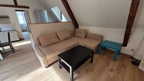 A modern living room with a sofa, a coffee table, and a small table. - T2 l Gant Devant la Mairie - Calme - Centre (Arras)