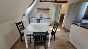 A compact kitchen with a white countertop, a built-in oven, and a refrigerator. - T2 l Gant Devant la Mairie - Calme - Centre (Arras)