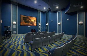 A conference room with rows of chairs, a large painting on the wall, and a patterned carpet. - Spacious Family Retreat w/ Pvt Pool + BBQ at Champions Gate (Davenport)