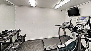 A gym with treadmills, a stationary bike, and a set of dumbbells. - All-suite 3br, Gulf Views: Suntide III - Unit 208 (South Padre Island)