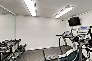 A gym with treadmills, a stationary bike, and a set of dumbbells. - All-suite 3br, Gulf Views: Suntide III - Unit 208 (South Padre Island)