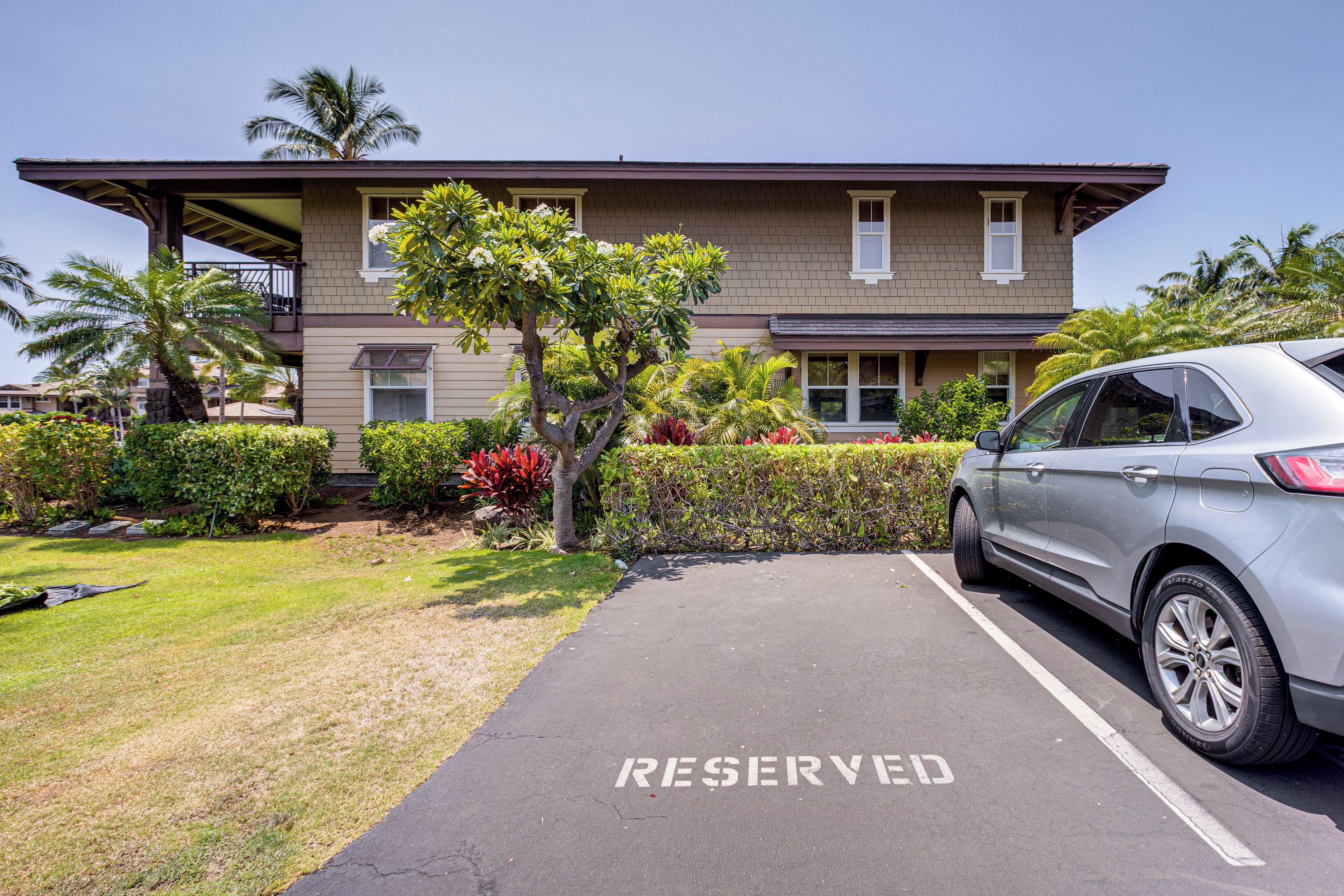 A building with a parking area marked 'RESERVED' and a parked car.