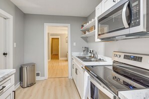 A modern kitchen with a stainless steel range, a microwave, and a built-in oven. - Walk to University of Akron! Game Day Getaway (Akron)