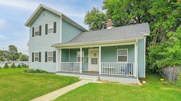 A two-story house with a front porch and a garage.