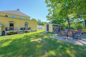 A yellow building with a covered patio area, outdoor seating, and a well-maintained lawn. - Near Bates & Bowdoin Colleges + Local Nature Park! (Lisbon)