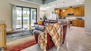 A spacious living area with a leather sofa, a glass coffee table, and a large window. - 6 Mi to Port Charlotte Beach Park! Family Getaway (Port Charlotte)