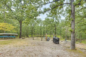A campground with picnic tables, a covered area, and a canoe. - Adventure Basecamp Near Lake Ouachita! (Mount Ida)