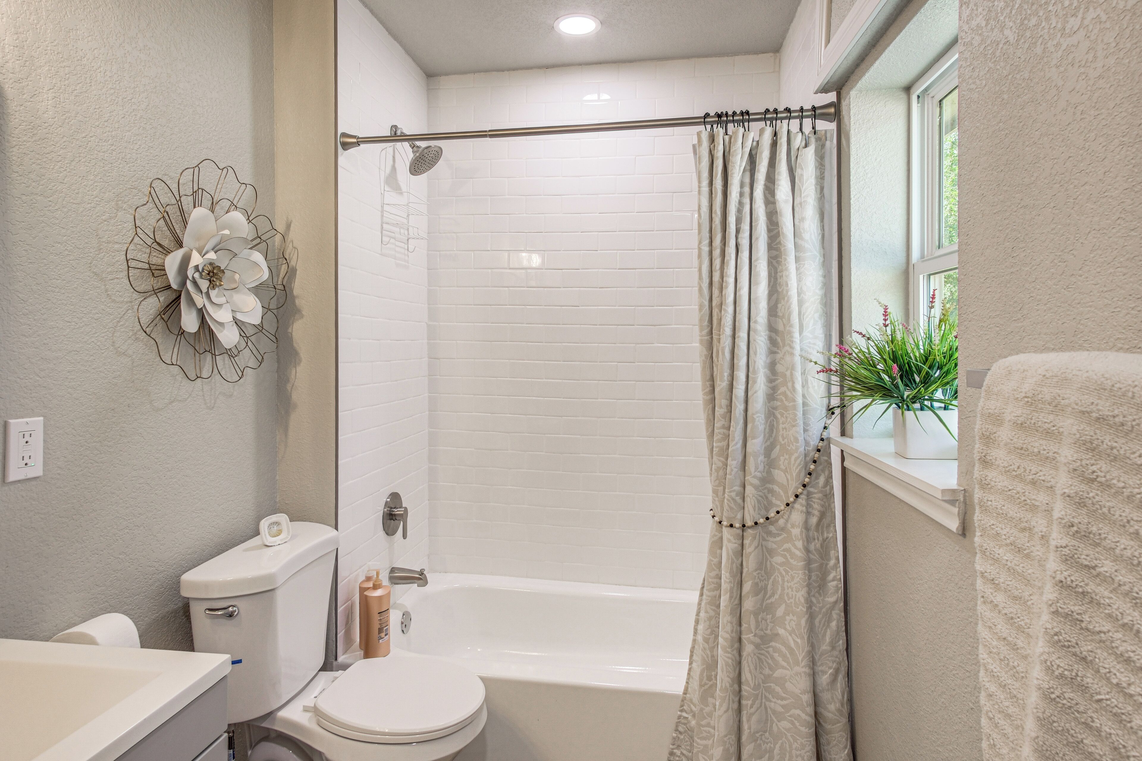 A bathroom with a toilet, a shower, and a bathtub.