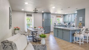 A modern kitchen with a central island, grey cabinets, and pendant lighting. - Boat Ramp Access! Canalfront Granbury Escape (Granbury)