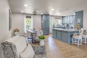 A modern kitchen with a central island, grey cabinets, and pendant lighting. - Boat Ramp Access! Canalfront Granbury Escape (Granbury)
