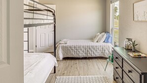 A bedroom with bunk beds, a desk, and a window with a view. - Boat Ramp Access! Canalfront Granbury Escape (Granbury)