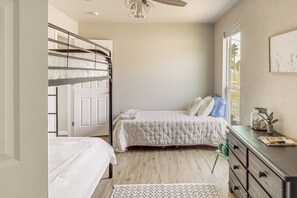 A bedroom with bunk beds, a desk, and a window with a view. - Boat Ramp Access! Canalfront Granbury Escape (Granbury)