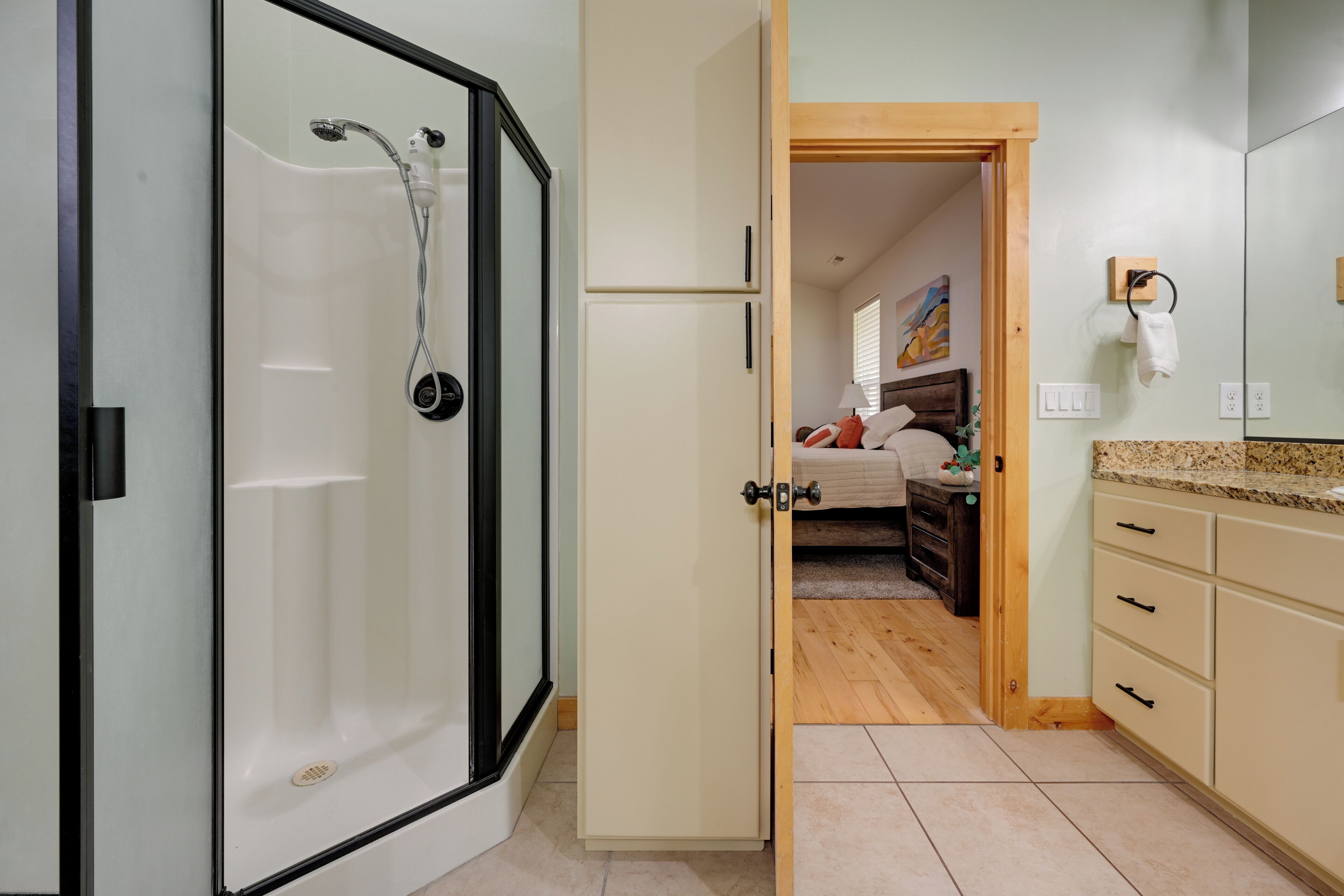 A bathroom with a shower, a toilet, and a sink.