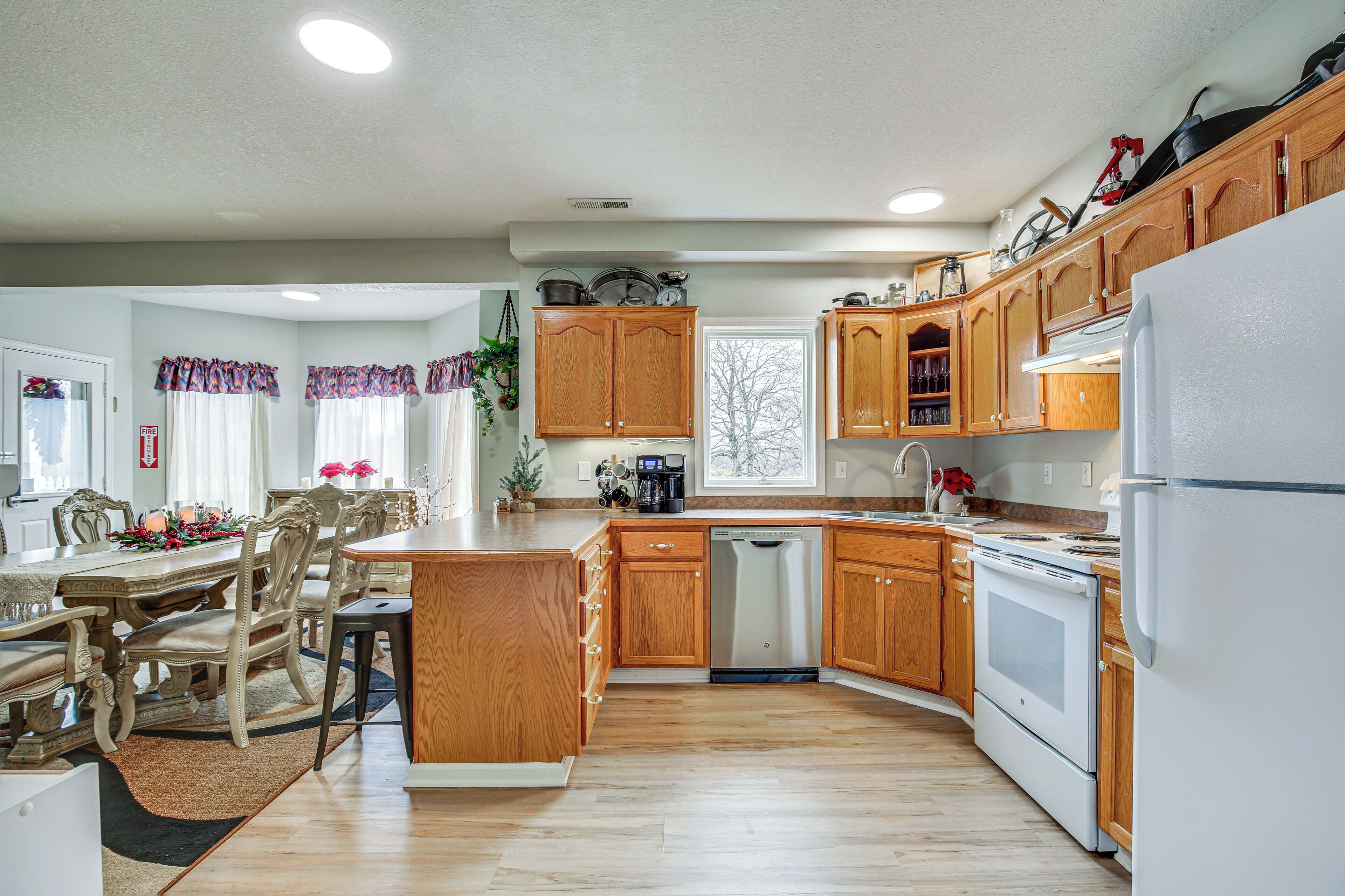 A modern kitchen with wooden cabinets, a dishwasher, and a refrigerator.
