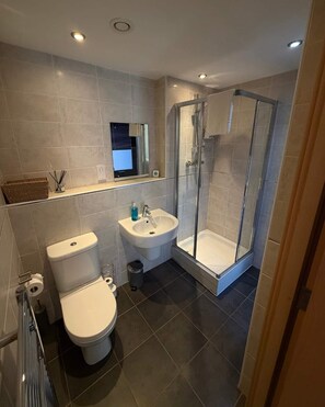 A modern bathroom with a toilet, bidet, sink, and glass-enclosed shower. - Stylish 2-Bed w/ Balcony | City Centre (Liverpool)