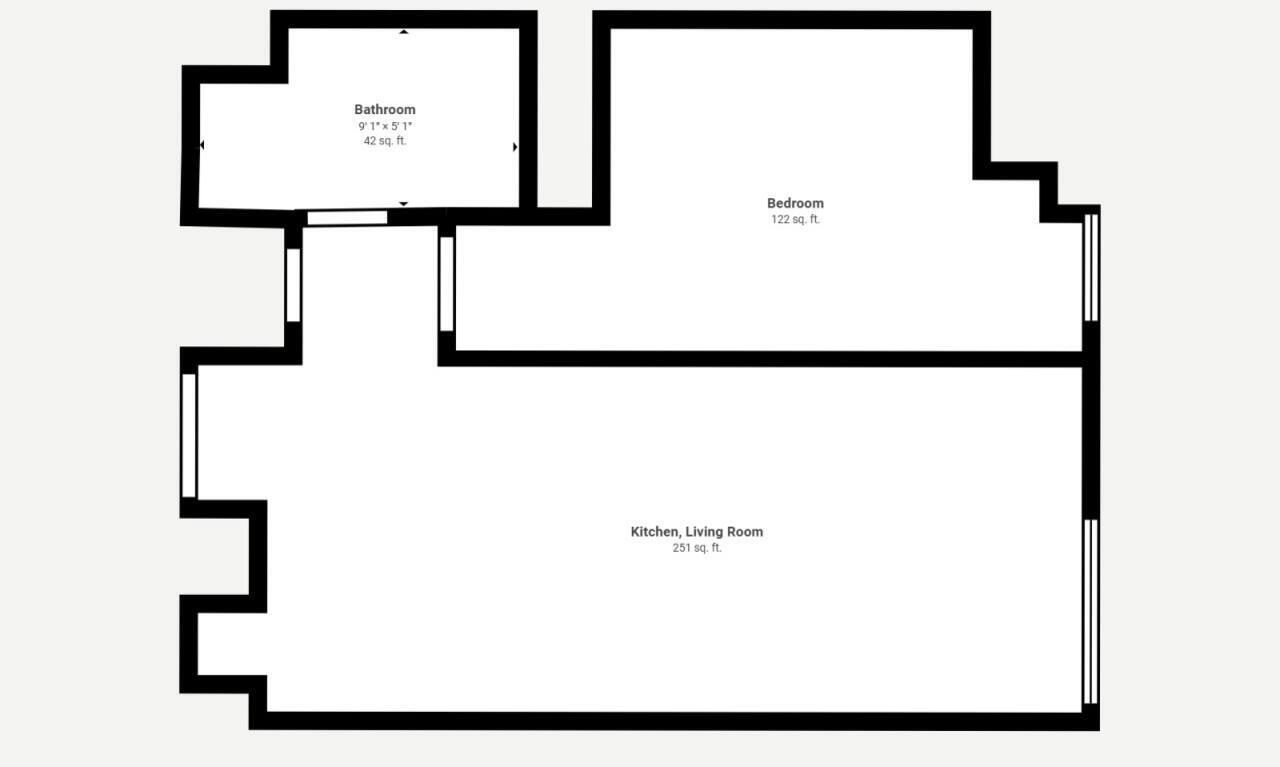 A floor plan with a bathroom, bedroom, and a combined kitchen and living room area.