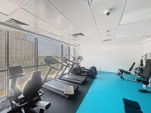 A gym with treadmills, elliptical machines, and weight equipment. - Aesthetic 2 Bed in Townsquare l Pool and Gym (Town Square)