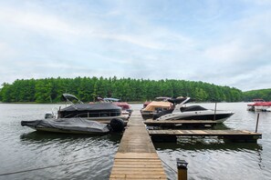A wooden dock leading to a calm lake with several boats docked. - FirePit, Hot Tub, Dock + Lake "Get Your Creek On" (Swanton)