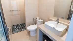 A bathroom with a toilet, sink, mirror, and shower. - Pondok Bali 2 Homestay (Canggu)