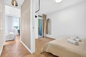 A modern hotel room with a bed, a bathroom, and a view of greenery. - Designer Flagship for 6 - by Presidential Palace (Bratislava)