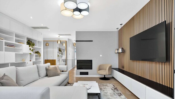 A modern living room with a sofa, TV, and built-in shelves. - Designer Flagship for 6 - by Presidential Palace (Bratislava)
