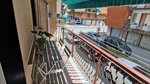 A balcony with a metal railing, a folding table, and a view of the street below. - On vacation but with all the comforts of home, just a 5-minute walk from the beach (Recco)
