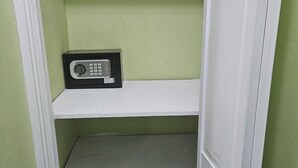 A storage closet with a white door and a shelf containing a radio. - Wonderful 1-bedroom house with AC in charming Marigot (Marigot)