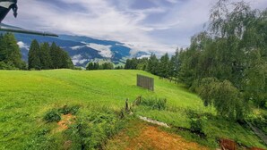 A grassy field with a wooden fence and trees, overlooking a valley with mountains in the distance. - Wonderful private villa for 17 guests with WIFI, TV and terrace (Pill)