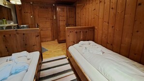 A wooden cabin room with two beds, a small table, and a mirror. - Wonderful private villa for 17 guests with WIFI, TV and terrace (Pill)
