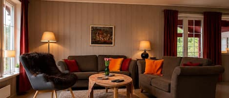 A living room with two sofas, a chair, a coffee table, and two lamps.