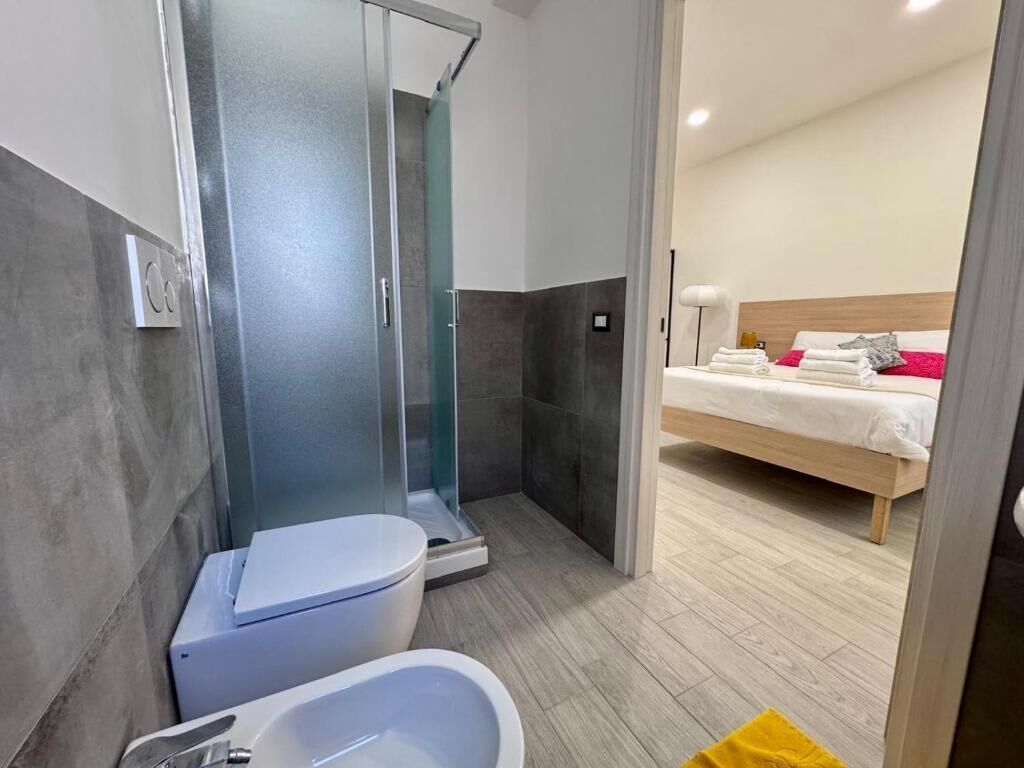 A modern bathroom with a shower, toilet, and bathtub.