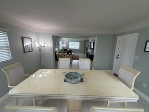 A dining area with a table, chairs, and a decorative bowl. - Launch Retreat on Merritt Island - Escape to the heart of Florida's Space Coast (Merritt Island)