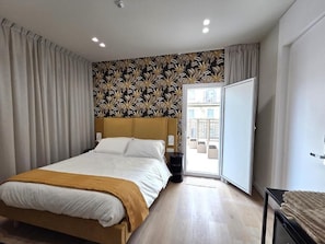 A modern bedroom with a bed, a wardrobe, and a view through a door. - Monteoliveto Place (Naples)