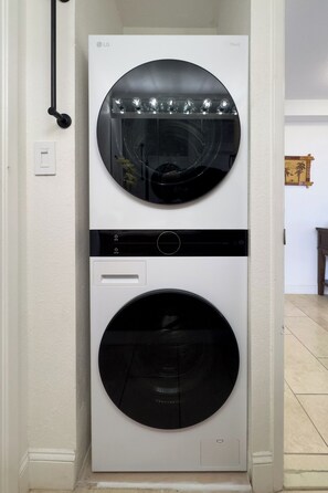 A stacked washer and dryer unit in a hallway. - Stunning Panoramic Ocean Views! 2bd/2Ba PH (Honolulu)