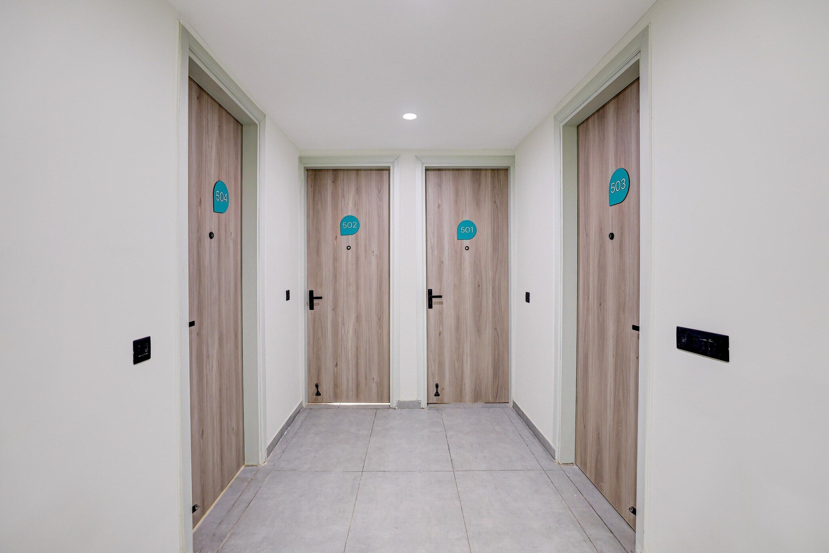 A hallway with four doors, each marked with a number.