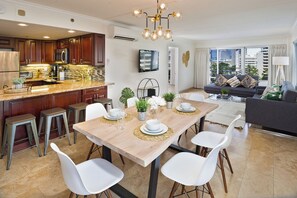 A modern kitchen with dark wood cabinets, a stainless steel refrigerator, and a marble countertop. - Gorgeous 2bd/2ba Ilikai Suite Steps from the Sand! (Honolulu)