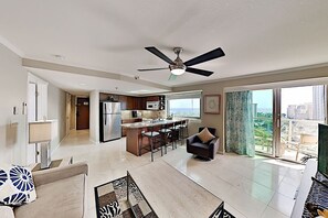A modern apartment with a kitchen, dining area, and a balcony with a city view. - 1BR Ocean View Luana Waikiki w/FREE PARKING! (Honolulu)