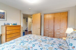 A bedroom with a bed, a wooden dresser, a wardrobe, and a bedside table with a lamp. - Private Girdwood Cabin w/ Sleeping Loft Near Alyeska (Girdwood)